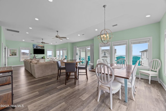 dining space featuring recessed lighting, wood finished floors, baseboards, a chandelier, and a ceiling fan