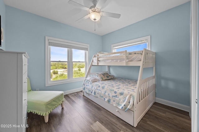 bedroom with baseboards, wood finished floors, and a ceiling fan