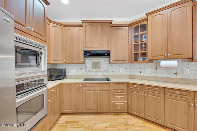 310 Garnercrest Rd, Wilmington, NC 28411 - kitchen featuring black appliances, under cabinet range hood, light wood-type flooring, glass insert cabinets, and light countertops