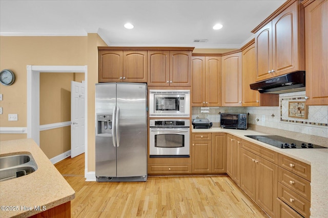 310 Garnercrest Rd, Wilmington, NC 28411 - kitchen featuring appliances with stainless steel finishes, under cabinet range hood, ornamental molding, light wood-type flooring, and tasteful backsplash