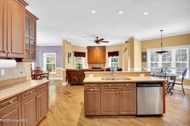310 Garnercrest Rd, Wilmington, NC 28411 - kitchen featuring dishwasher, a sink, ornamental molding, light wood-style flooring, and tasteful backsplash