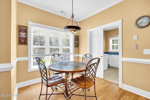310 Garnercrest Rd, Wilmington, NC 28411 - dining space with light wood-style flooring, baseboards, and ornamental molding