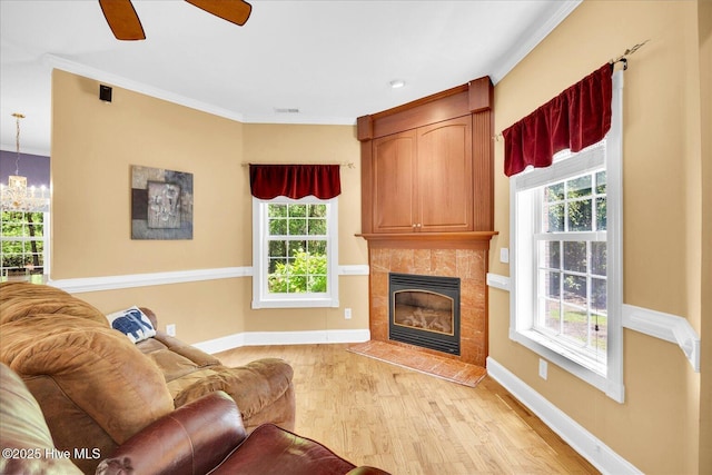 310 Garnercrest Rd, Wilmington, NC 28411 - living area with light wood-type flooring, plenty of natural light, a tile fireplace, baseboards, and crown molding