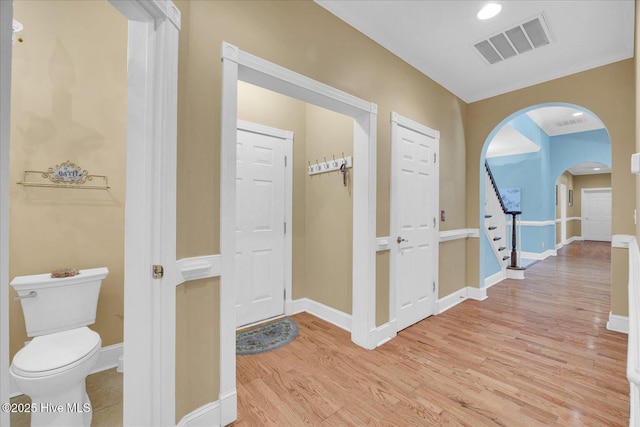 310 Garnercrest Rd, Wilmington, NC 28411 - hall featuring arched walkways, light wood-style flooring, baseboards, and stairs
