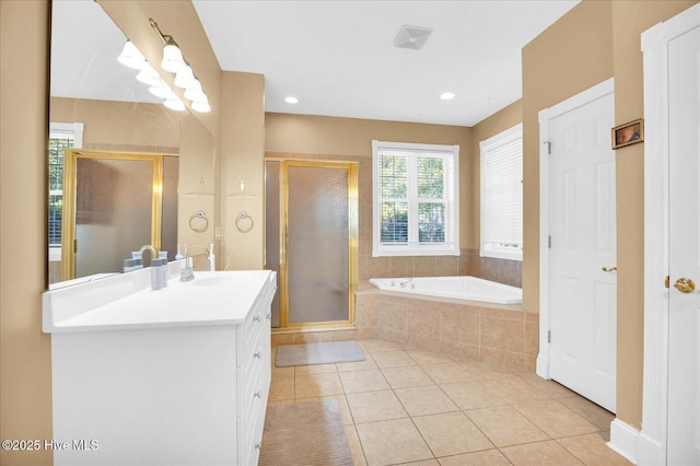 310 Garnercrest Rd, Wilmington, NC 28411 - bathroom with vanity, a stall shower, a garden tub, and tile patterned floors