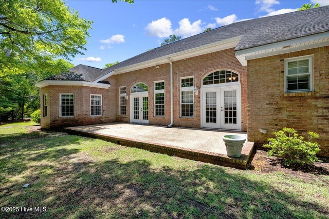 310 Garnercrest Rd, Wilmington, NC 28411 - back of property featuring french doors, brick siding, a lawn, and a patio area