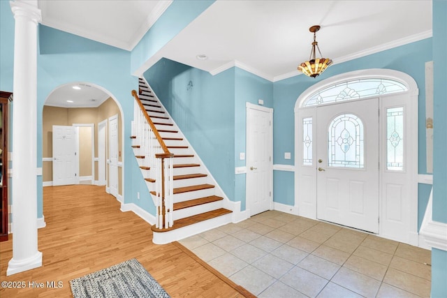 310 Garnercrest Rd, Wilmington, NC 28411 - foyer featuring arched walkways, stairs, wood finished floors, crown molding, and baseboards