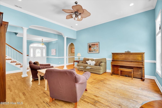 310 Garnercrest Rd, Wilmington, NC 28411 - living room with arched walkways, decorative columns, wood finished floors, a ceiling fan, and stairs