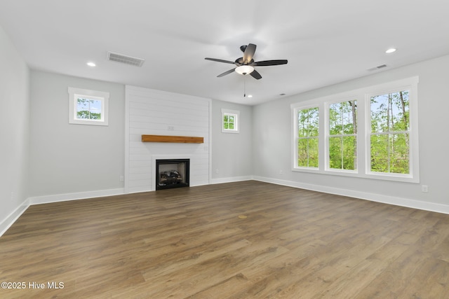 unfurnished living room with plenty of natural light, baseboards, a ceiling fan, and recessed lighting