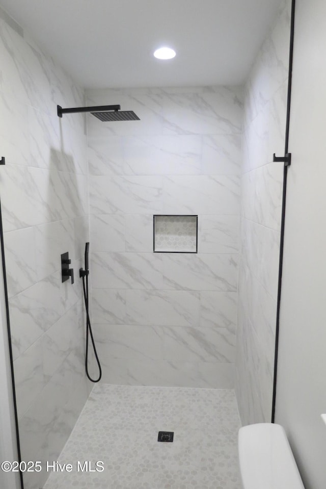 full bathroom featuring a shower stall, toilet, and recessed lighting