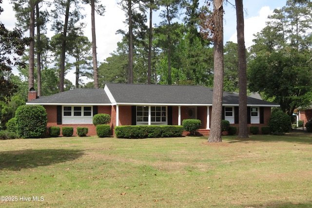 ranch-style house with a front yard, brick siding, and covered porch