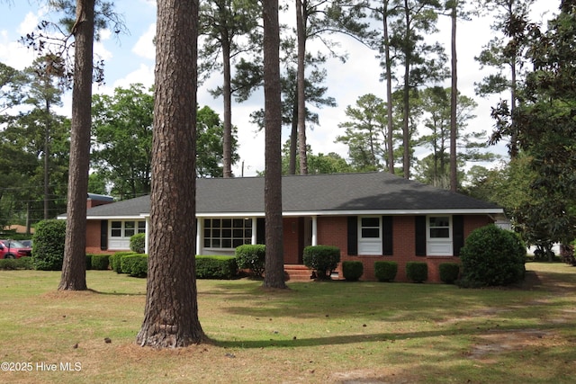 ranch-style home with brick siding and a front lawn