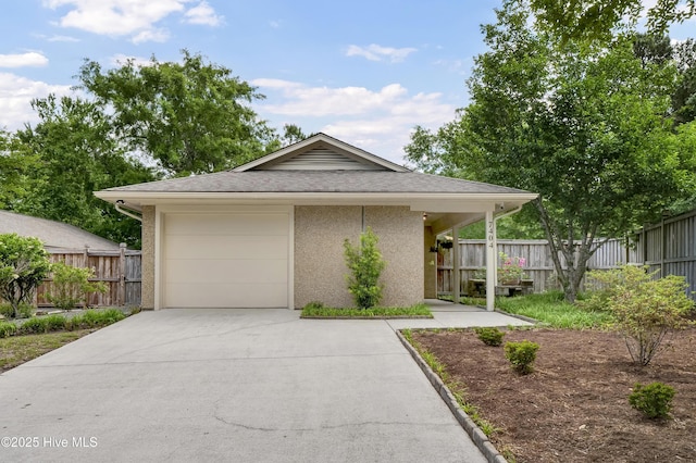 7404 Countywood Way, Wilmington, NC 28411 - view of front of property featuring concrete driveway, fence, stucco siding, an attached garage, and roof with shingles