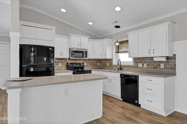7404 Countywood Way, Wilmington, NC 28411 - kitchen featuring black appliances, vaulted ceiling, a sink, a center island, and white cabinets