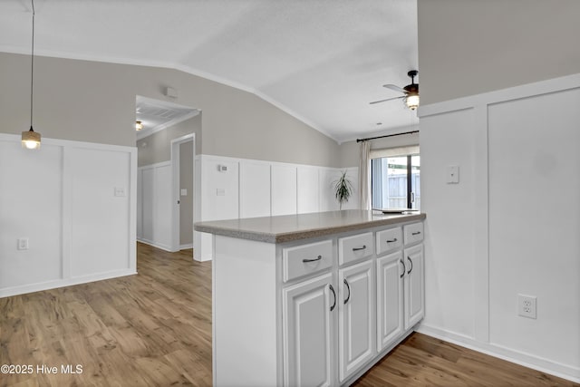 7404 Countywood Way, Wilmington, NC 28411 - kitchen featuring lofted ceiling, a decorative wall, light wood finished floors, a ceiling fan, and white cabinets