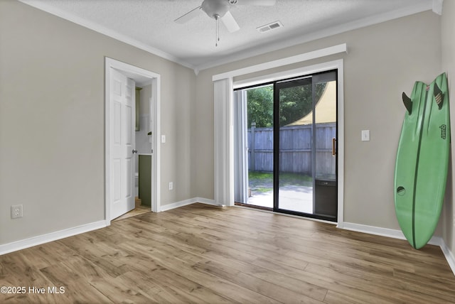 7404 Countywood Way, Wilmington, NC 28411 - spare room with ceiling fan, ornamental molding, wood finished floors, a textured ceiling, and baseboards