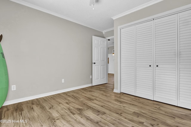 7404 Countywood Way, Wilmington, NC 28411 - unfurnished bedroom featuring ornamental molding, wood finished floors, baseboards, and a closet