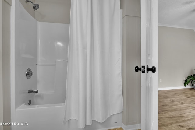 7404 Countywood Way, Wilmington, NC 28411 - bathroom featuring shower / bath combination with curtain, baseboards, wood finished floors, and ornamental molding