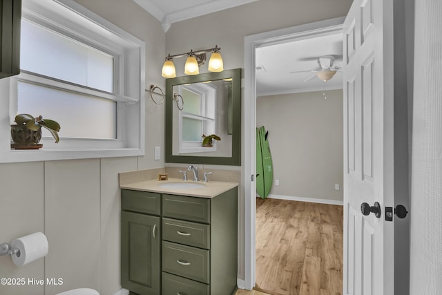 7404 Countywood Way, Wilmington, NC 28411 - bathroom featuring crown molding, wood finished floors, ceiling fan, vanity, and baseboards