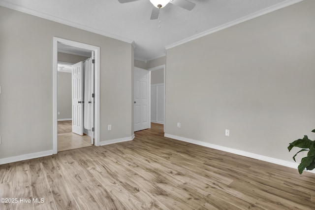 7404 Countywood Way, Wilmington, NC 28411 - unfurnished bedroom featuring ornamental molding, light wood-style flooring, baseboards, and a ceiling fan