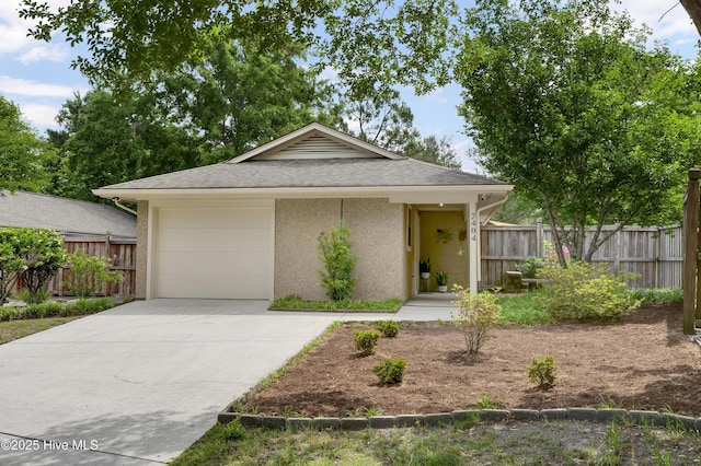 7404 Countywood Way, Wilmington, NC 28411 - view of front of home featuring concrete driveway, fence, stucco siding, and a garage