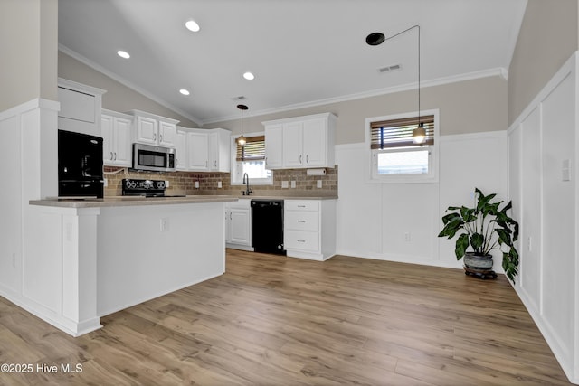 7404 Countywood Way, Wilmington, NC 28411 - kitchen featuring black appliances, backsplash, white cabinets, light wood-style flooring, and ornamental molding