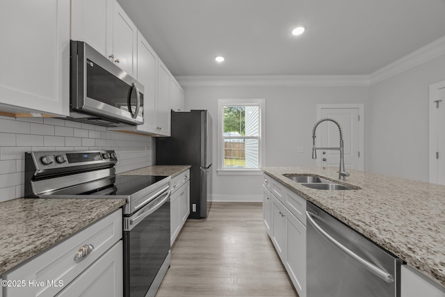 104 Two Sisters Ter, Sneads Ferry, NC 28460 - kitchen featuring appliances with stainless steel finishes, a sink, ornamental molding, tasteful backsplash, and white cabinets