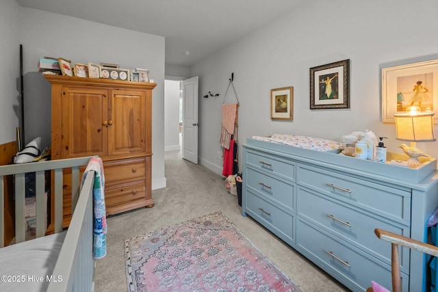 bedroom featuring light carpet and baseboards