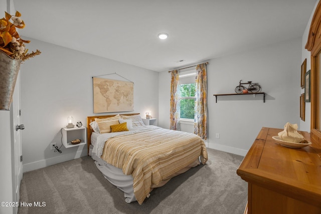 carpeted bedroom featuring baseboards and recessed lighting