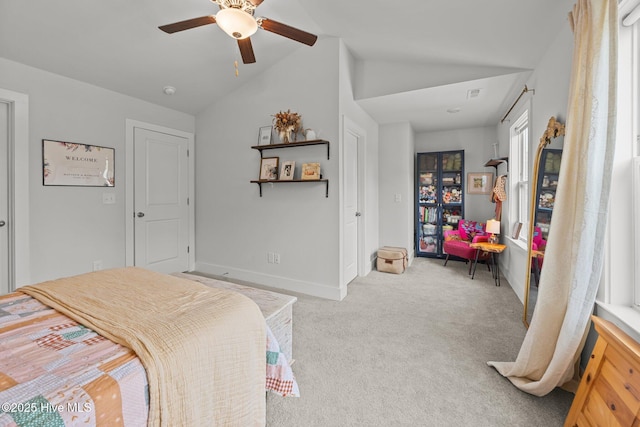 bedroom with carpet flooring, lofted ceiling, baseboards, and a ceiling fan