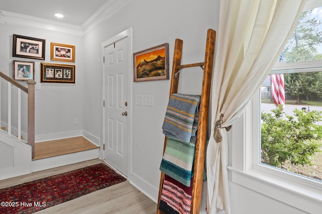 entrance foyer with wood finished floors, crown molding, stairway, baseboards, and recessed lighting