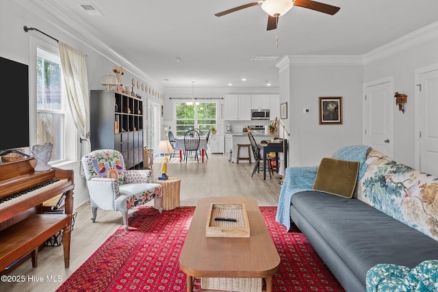 living room featuring light wood-style floors, a ceiling fan, ornamental molding, and recessed lighting