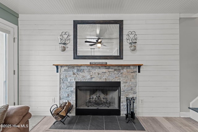 2 Harbour Walk, New Bern, NC 28562 - detailed view of a stone fireplace, wood finished floors, wooden walls, and ceiling fan