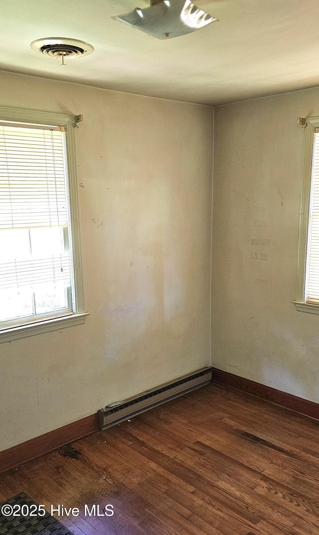 1122 Zion Church Rd, Conway, NC 27820 - unfurnished room with baseboard heating, dark wood-type flooring, and baseboards