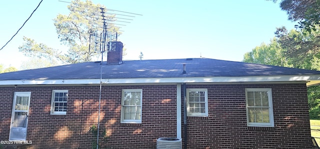 1122 Zion Church Rd, Conway, NC 27820 - back of property with brick siding, a chimney, central AC, and a shingled roof
