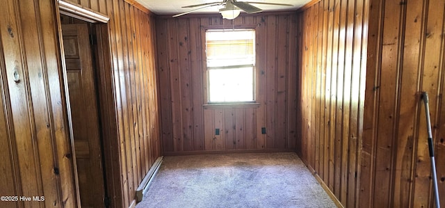 1122 Zion Church Rd, Conway, NC 27820 - spare room featuring carpet flooring, a ceiling fan, wooden walls, and baseboard heating