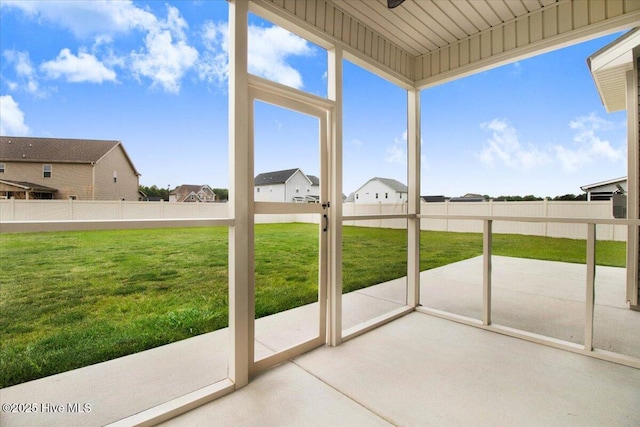 unfurnished sunroom featuring a residential view