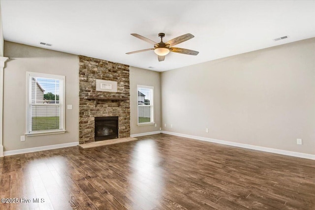 unfurnished living room featuring ceiling fan, dark wood-style flooring, and a healthy amount of sunlight