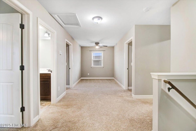 hall with baseboards, light carpet, and an upstairs landing