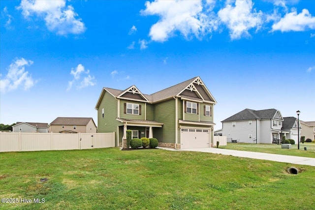 craftsman house featuring fence, an attached garage, a front lawn, and driveway