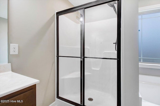 full bathroom with a stall shower and vanity