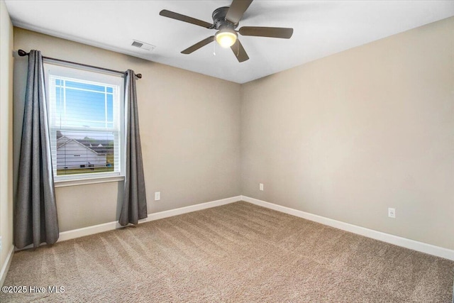 empty room with baseboards, visible vents, and carpet