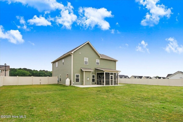 rear view of property with a sunroom, a patio, a lawn, and a fenced backyard