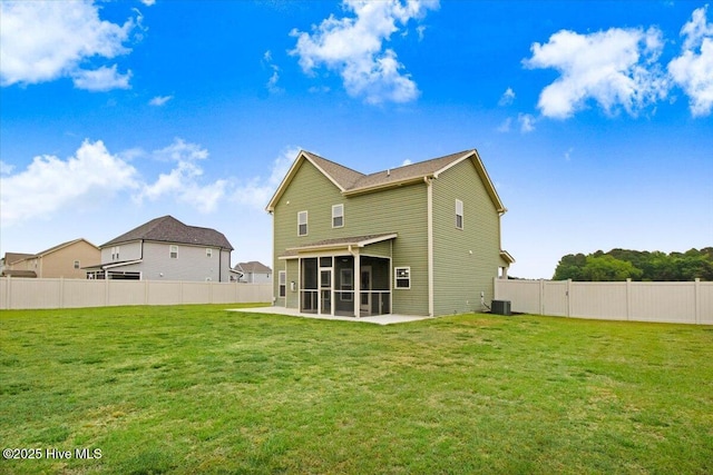 back of house with a yard, central air condition unit, a sunroom, and a fenced backyard
