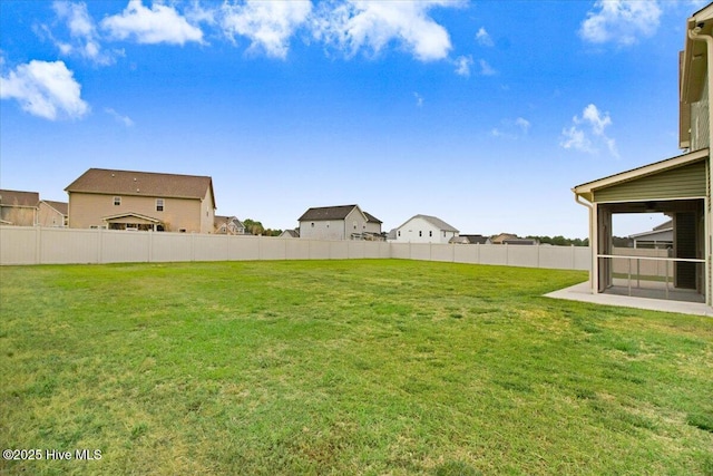 view of yard with a sunroom, fence, and a residential view