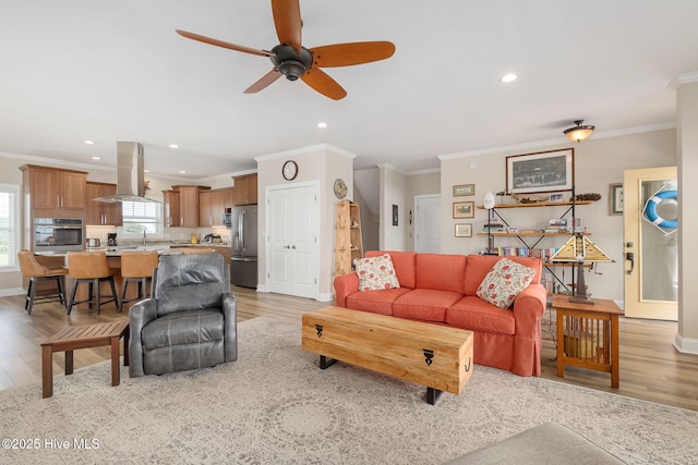 139 Sound Point Dr, Harkers Island, NC 28531 - living area featuring ornamental molding, light wood-style flooring, recessed lighting, ceiling fan, and baseboards