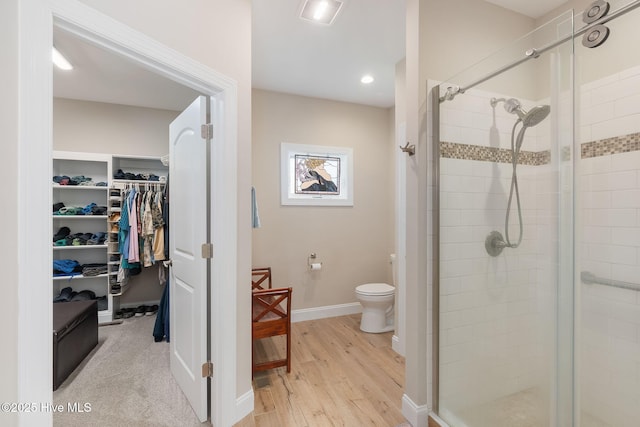 139 Sound Point Dr, Harkers Island, NC 28531 - full bathroom with a shower stall, a walk in closet, toilet, baseboards, and wood finished floors