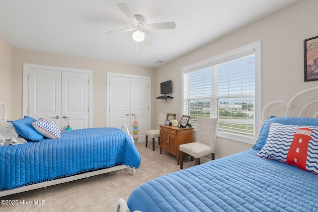 139 Sound Point Dr, Harkers Island, NC 28531 - bedroom featuring carpet, multiple closets, and a ceiling fan