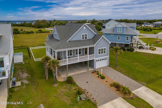 139 Sound Point Dr, Harkers Island, NC 28531 - view of front of home featuring decorative driveway, an attached garage, a residential view, a shingled roof, and a porch