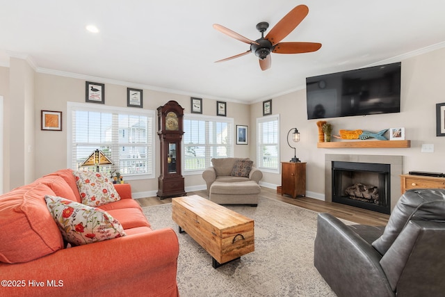 139 Sound Point Dr, Harkers Island, NC 28531 - living area featuring wood finished floors, crown molding, a ceiling fan, a fireplace, and baseboards